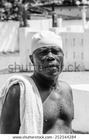 KARA, TOGO - MAR 9, 2013: Unidentified Togolese serious man with a towel on his shoulder. People in Togo suffer of poverty due to the unstable econimic situation