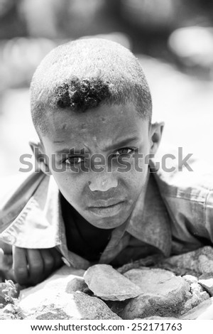 AKSUM, ETHIOPIA - SEP 24, 2011: Unidentified Ethiopian cute little boy with a funny haircut in Ethiopia, Sep.24, 2011. Children in Ethiopia suffer of poverty due to the unstable situation
