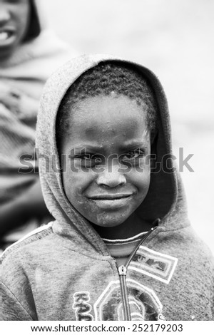 OMO VALLEY, ETHIOPIA - SEP 22, 2011: Unidentified Ethiopian girl covered by warm clothes in Ethiopia, Sep.22, 2011. People in Ethiopia suffer of poverty due to the unstable situation