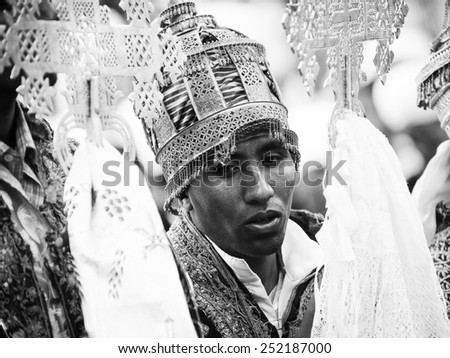 LALIBELA, ETHIOPIA - SEP 27, 2011: Unidentified Ethiopian religious man holds the golden cross and speaks during the Meskel festival. Meskel commemorates the finding of the True Cross
