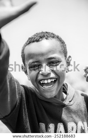 OMO VALLEY, ETHIOPIA - SEP 19, 2011: Unidentified Ethiopian boy feels joy of the life, in Ethiopia, Sep.19, 2011. People in Ethiopia suffer of poverty due to the unstable situation