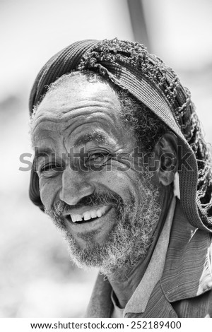 AKSUM, ETHIOPIA - SEP 24, 2011: Unidentified Ethiopian old man in a hat smiles in Ethiopia, Sep.24, 2011. People in Ethiopia suffer of poverty due to the unstable situation