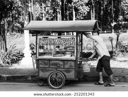 SIEMREAP, CAMBODIA - SEP 26, 2014: Unidentified Khmer woman sells bread in the street. 90% of Cambodian people belong to Khmer etnic group
