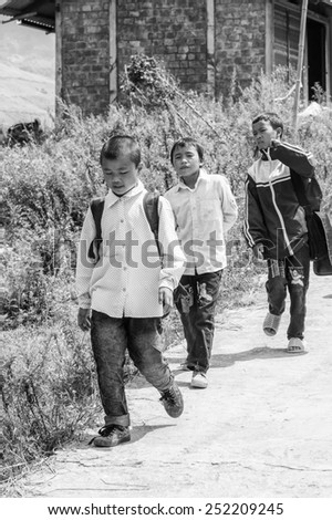 LAO CHAI VILLAGE, VIETNAM - SEP 22, 2014: Unidentified Hmong children goes back from the school in Lao Chai. Hmong is on of the minority eethnic group in Vietnam