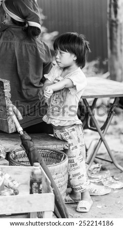 TA PHIN, LAO CAI, VIETNAM - SEP 21, 2014:  Unidentified Red Dao girl plays outside. Red Dao is one of the minority ethnic groups in Vietnam
