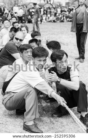 NORTH KOREA - MAY 1, 2012: Korean people are separating into 2 teams for tug of war game during the celebration of the International Worker\'s Day, May 1. May 1 is a national holiday in 80 countries