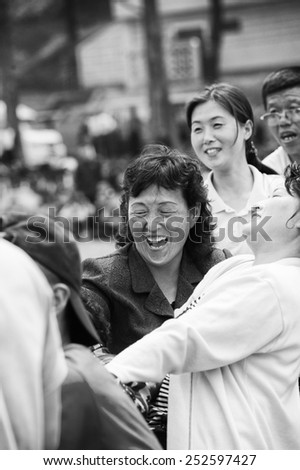 NORTH KOREA - MAY 1, 2012: Korean man emotionally participates in the tug of war game during the celebration of the Worker\'s Day in N.Korea, May 1, 2012. May 1 is a national holiday in 80 countries