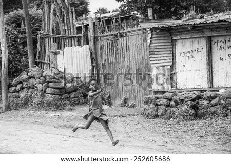 OMO, ETHIOPIA - SEPTEMBER 19, 2011: Unidentified Ethiopian girl runs happily. People in Ethiopia suffer of poverty due to the unstable situation
