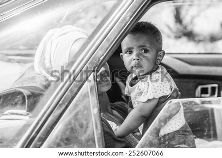 OMO, ETHIOPIA - SEPTEMBER 21, 2011: Unidentified Ethiopian boy with his mother in the car. People in Ethiopia suffer of poverty due to the unstable situation