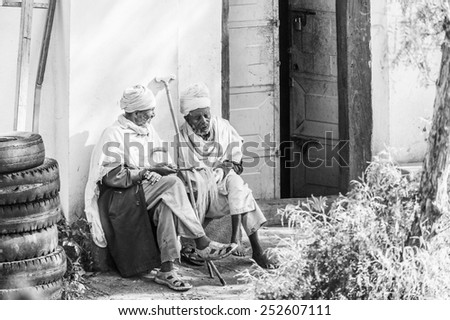 OMO, ETHIOPIA - SEPTEMBER 21, 2011: Unidentified Ethiopian old men in white tissue. People in Ethiopia suffer of poverty due to the unstable situation