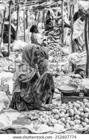 OMO, ETHIOPIA - SEPTEMBER 19, 2011: Unidentified Ethiopian woman sells potatoes at the local market. People in Ethiopia suffer of poverty due to the unstable situation