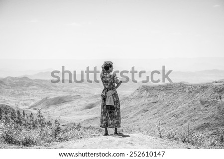OMO, ETHIOPIA - SEPTEMBER 21, 2011: Unidentified Ethiopian woman from behind. People in Ethiopia suffer of poverty due to the unstable situation