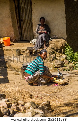 OMO, ETHIOPIA - SEPTEMBER 21, 2011: Unidentified Ethiopian woman cooks in the street. People in Ethiopia suffer of poverty due to the unstable situation