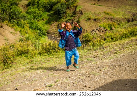 OMO, ETHIOPIA - SEPTEMBER 21, 2011: Unidentified Ethiopian boy runs. People in Ethiopia suffer of poverty due to the unstable situation