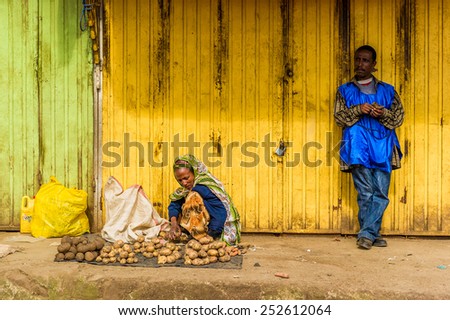 OMO, ETHIOPIA - SEPTEMBER 21, 2011: Unidentified Ethiopian woman sells potatoes. People in Ethiopia suffer of poverty due to the unstable situation