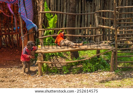 OMO, ETHIOPIA - SEPTEMBER 19, 2011: Unidentified Ethiopian little boys on a wooden bench. People in Ethiopia suffer of poverty due to the unstable situation