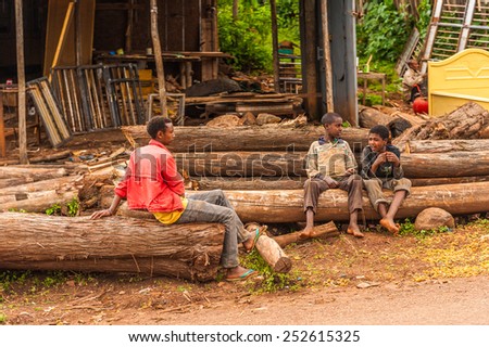 OMO, ETHIOPIA - SEPTEMBER 19, 2011: Unidentified Ethiopian boys on the log. People in Ethiopia suffer of poverty due to the unstable situation
