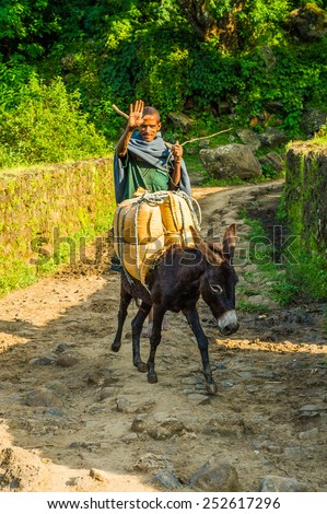 OMO, ETHIOPIA - SEPTEMBER 19, 2011: Unidentified Ethiopian man on a donkey. People in Ethiopia suffer of poverty due to the unstable situation