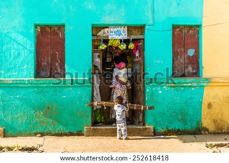 OMO, ETHIOPIA - SEPTEMBER 21, 2011: Unidentified Ethiopian little boy helps his mother in the street. People in Ethiopia suffer of poverty due to the unstable situation