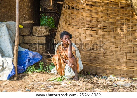 OMO, ETHIOPIA - SEPTEMBER 19, 2011: Unidentified Ethiopian woman thinks of something. People in Ethiopia suffer of poverty due to the unstable situation