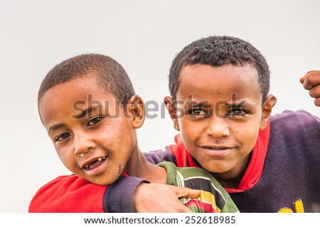OMO, ETHIOPIA - SEPTEMBER 19, 2011: Unidentified Ethiopian two friends. People in Ethiopia suffer of poverty due to the unstable situation