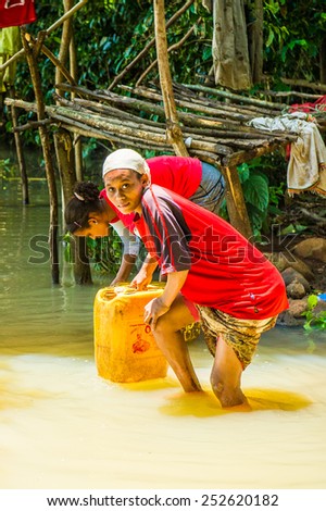 OMO, ETHIOPIA - SEPTEMBER 20, 2011: Unidentified Ethiopian women getting water. People in Ethiopia suffer of poverty due to the unstable situation