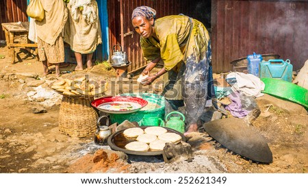 OMO, ETHIOPIA - SEPTEMBER 19, 2011: Unidentified Ethiopian woman makes pancakes at the local market. People in Ethiopia suffer of poverty due to the unstable situation