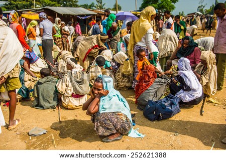 OMO, ETHIOPIA - SEPTEMBER 19, 2011: Unidentified Ethiopian people and children at the local market. People in Ethiopia suffer of poverty due to the unstable situation
