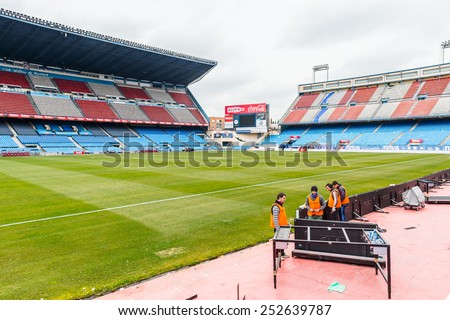 MADRID, SPAIN - FEB 11, 2015: Unidentified workers at the Vicente Calderon Football Stadium. It's the home stadium of La Liga football club Atletico Madrid