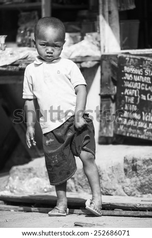 ANTANANARIVO, MADAGASCAR - JUNE 30, 2011: Unidentified Madagascar boy runs at the market. People in Madagascar suffer of poverty due to the slow development of the country