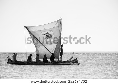 ANTANANARIVO, MADAGASCAR - JULY 3, 2011: Unidentified Madagascar people on a small boat. People in Madagascar suffer of poverty due to slow development of the country
