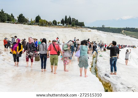 PAMUKKALE, TURKEY - APR 18, 2015: Unidentified tourists on the travertines of Pamukkale, Turkey. It\'s a UNESCO World Heritage site
