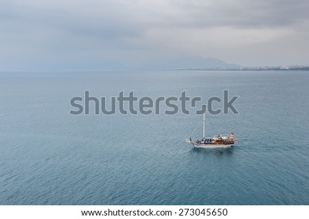 ANTALYA, TURKEY - APR 19, 2015: Touristic yacht on the Mediterranean sea near the Old harbour in Antalya (Kaleici), Turkey.  Mediterranean sea is 2,500,000 km2
