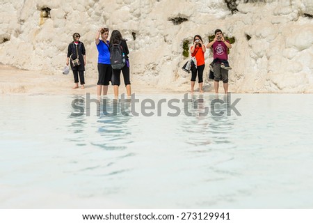 PAMUKKALE, TURKEY - APR 18, 2015: Unidentified tourists in a hot spring on the travertines of Pamukkale, Turkey. It's a UNESCO World Heritage site