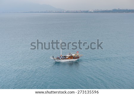 ANTALYA, TURKEY - APR 19, 2015: Touristic yacht on the Mediterranean sea near the Old harbour in Antalya (Kaleici), Turkey.  Mediterranean sea is 2,500,000 km2