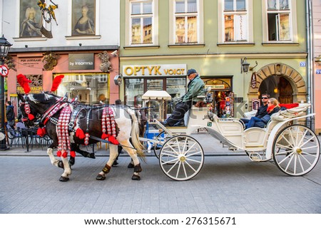 KRAKOW, POLAND - APR 29, 2015: Horse carriage in the Old town of Krakow, Poland. Old Town of Krakow is one of most famous old areas in Poland