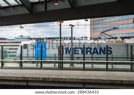 AMSTERDAM, NETHERLANDS - JUN 1, 2015: Train witn Metrans logo at Amsterdam Bijlmer ArenA metro station. It\'s a  railway station in the Bijlmermeer neighbourhood of the Amsterdam Zuidoost stadsdeel