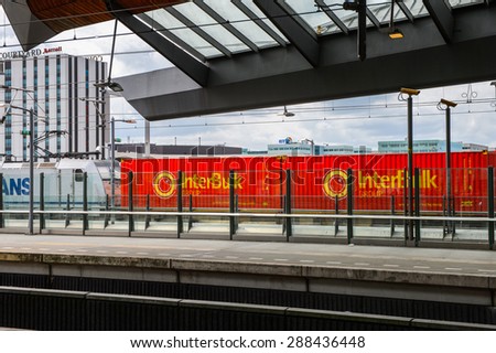 AMSTERDAM, NETHERLANDS - JUN 1, 2015: Train witn Interbuk logo at Amsterdam Bijlmer ArenA metro station. It\'s a  railway station in the Bijlmermeer neighbourhood of the Amsterdam Zuidoost stadsdeel