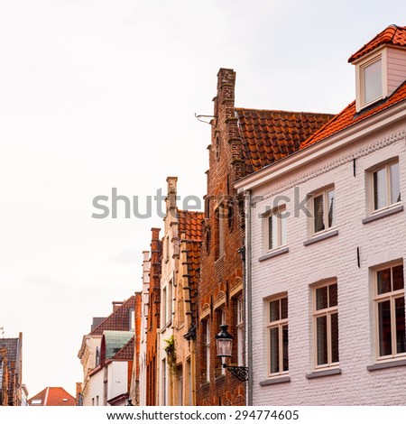 Medieval houses with flowers at the windows in the Historic Centre of Bruges, Belgium. part of the UNESCO World Heritage site