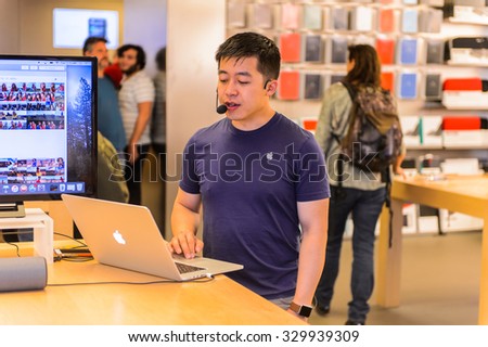 NEW YORK, USA - SEP 22, 2015: Unidentified consulter at the  Apple store on the Fifth Avenue, New York.The store sells Macintosh personal computers, software, iPod, iPad, iPhone, Apple Watch, Apple TV