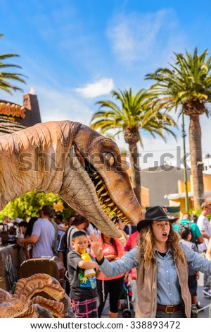 LOS ANGELES, USA - SEP 27, 2015: Realistic velociraptor in Jurassic Park area in the Universal Studios Hollywood Park. Jurassic Park is a 1993  adventure film  by Steven Spielberg