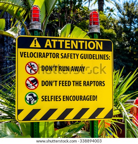 LOS ANGELES, USA - SEP 27, 2015: Attention sign in Jurassic Park area in the Universal Studios Hollywood Park. Jurassic Park is a 1993 American adventure film  by Steven Spielberg