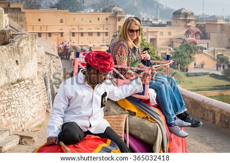 JAIPUR, INDIA - JAN 19, 2016: Unidentified Indian man rides an elephant. Indian elephants used to be one of the main way of transportation in the past