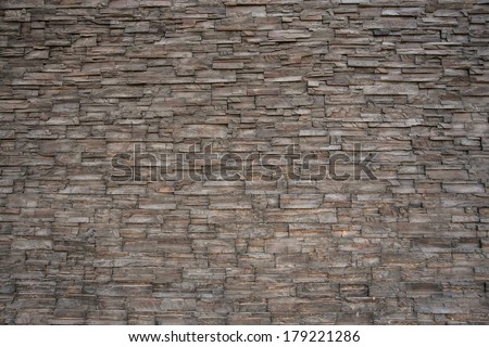 Dark grey stone tile texture brick wall surfaced.