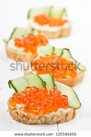 Sandwiches with red caviar, cucumber and cream cheese