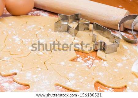 The process of baking homemade Christmas cookies. Cutting cookie molds.