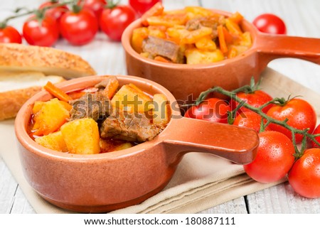 Stewed potatoes with meat, carrots and tomatoes