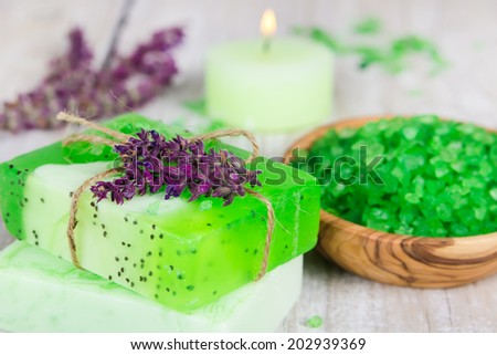 Aroma spa set on wooden background with flowers of sage