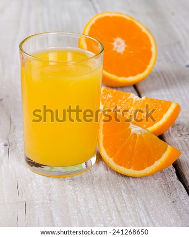 Fresh orange juice on a wooden background