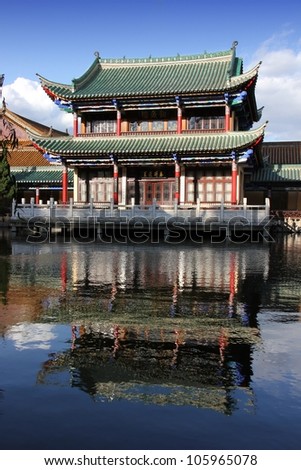 Typical ancient Chinese style building with reflections in water.